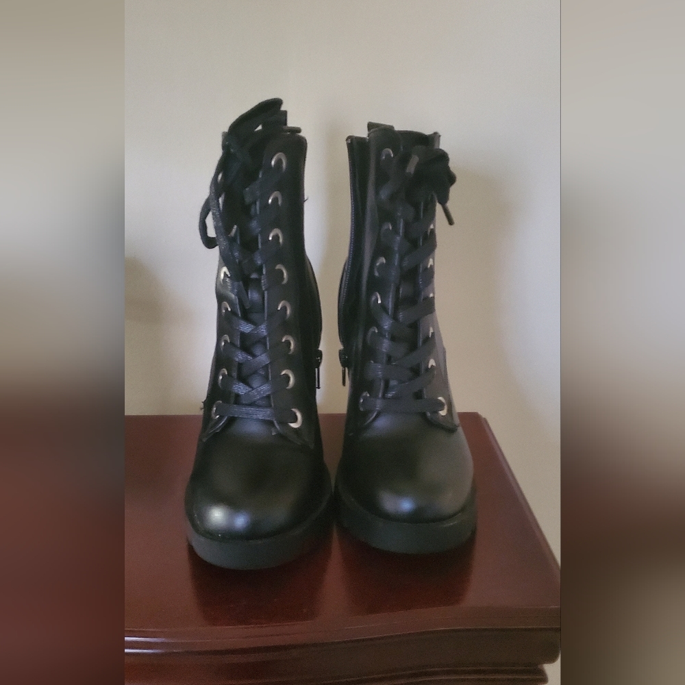 Black boots with heels. Zip up. Size 6 1/2. Worn once.